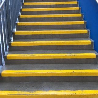 concrete steps after they have been cleaned, the concrete is shiny and the yellow has no marks at all