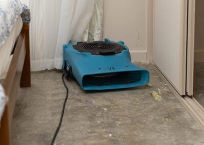 drying fan in bedroom, after carpet has been lifted