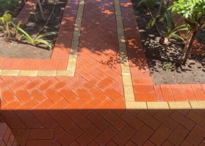 cleaning outdoor pavers, red bricks shining in the sunlight, walkway is super clean