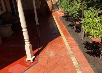 cleaning outdoor pavers, red bricks shining on walk way around veranda of home