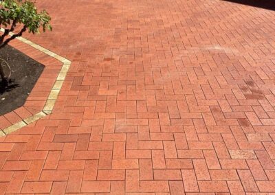 cleaning outdoor pavers, all done, red brick shining through