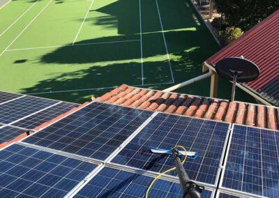 cleaning solar panels on tennis house