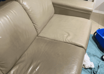 leather couch cleaning in progress, one section of couch done